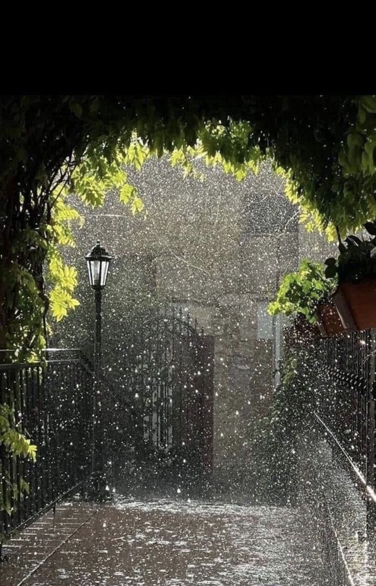 an open umbrella sitting on top of a wet sidewalk