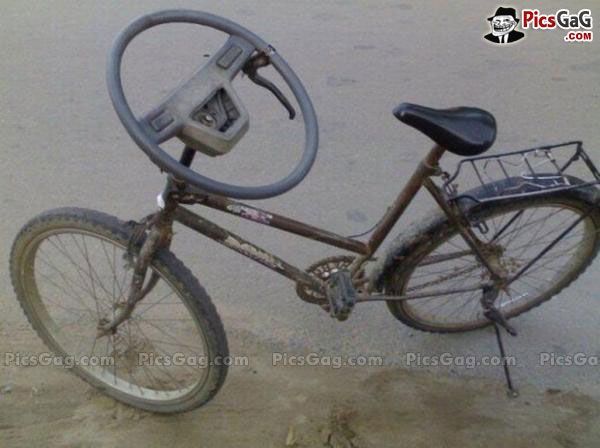 a bike with a basket attached to the front wheel and seat is leaning against a wall