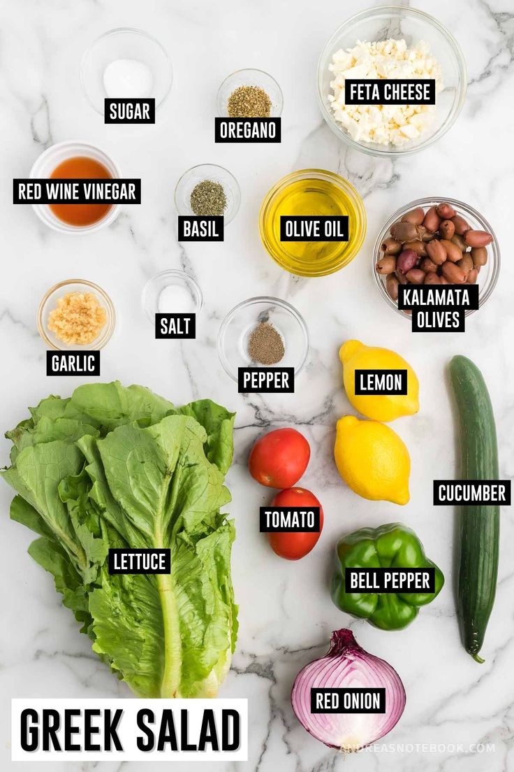 the ingredients for greek salad laid out on a white marble counter top with text overlay