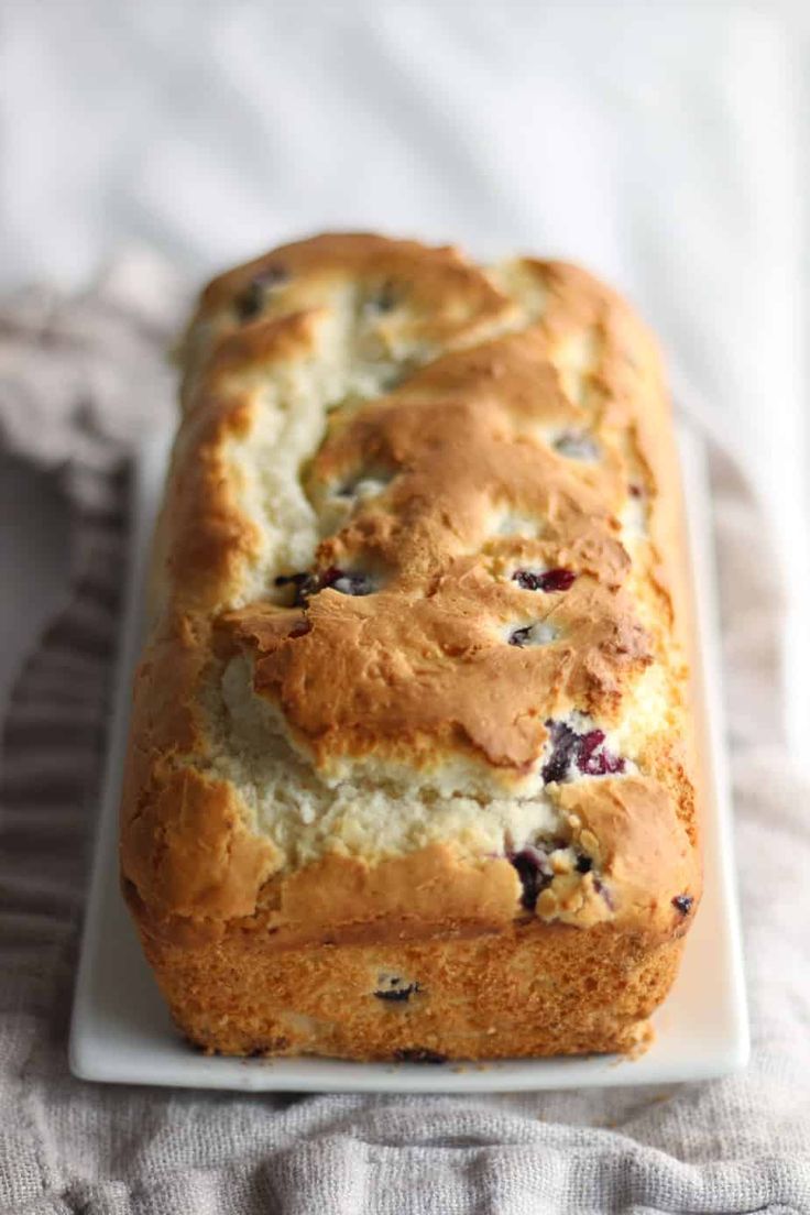 a loaf of blueberry bread on a white plate