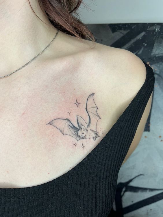 a woman with a bat tattoo on her chest