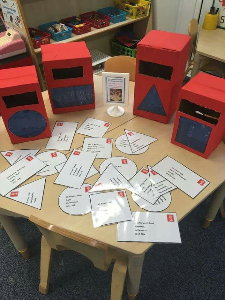 some red boxes sitting on top of a table with white cards and papers in front of them