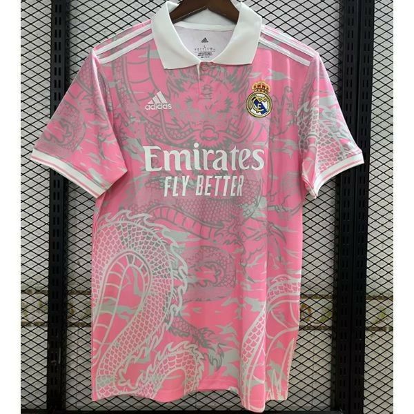 a pink shirt hanging up against a wall with the word emirates fly - beth on it