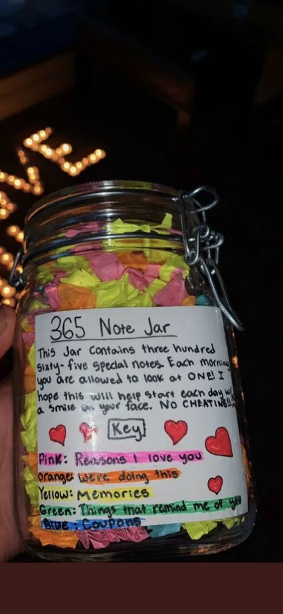 a jar filled with lots of candy next to a lit up sign that says 365 note jar