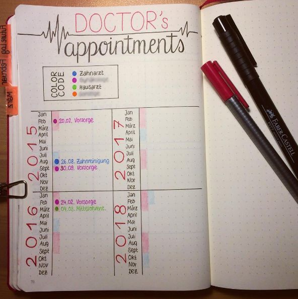 a doctor's appointment book is open with markers and pens on top of it