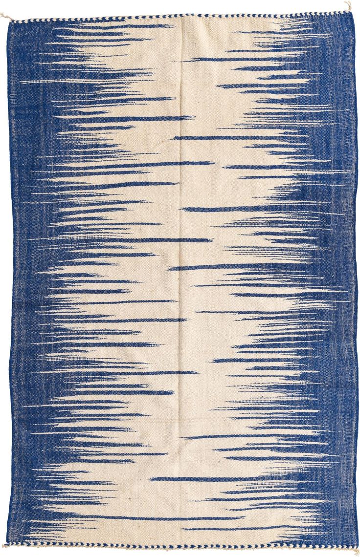 a blue and white rug with fringes on it