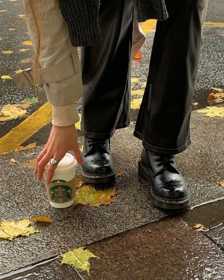 a person with their foot on a starbucks cup