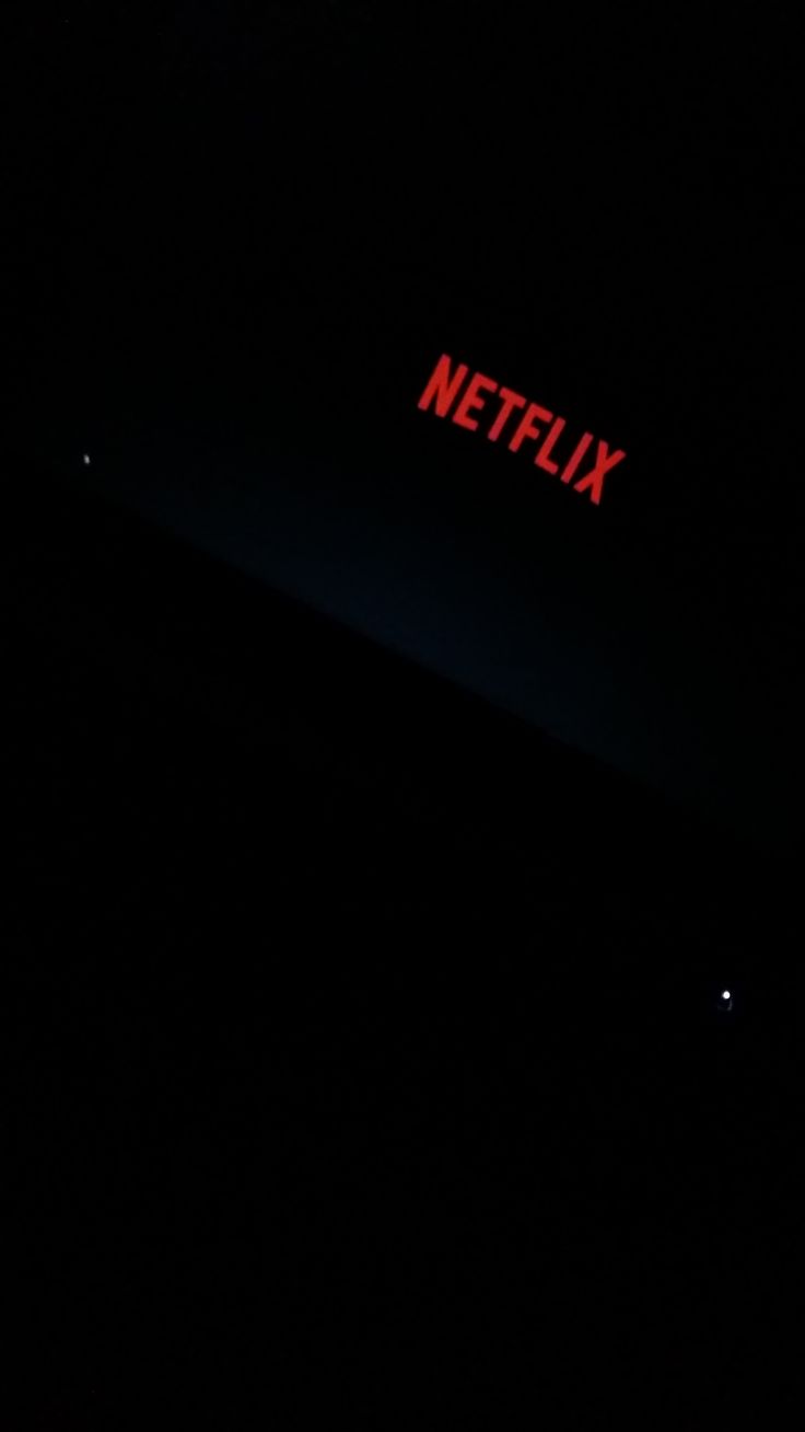 the netflix logo is lit up in the dark