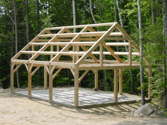 a wooden structure in the middle of a forest