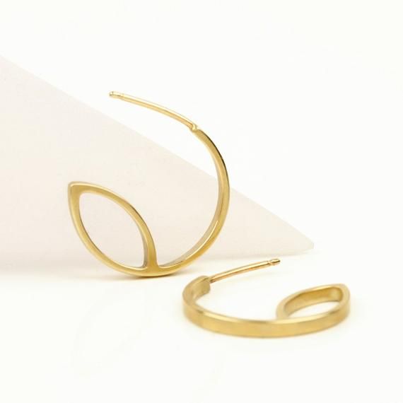 Unique 14k gold hoop earrings, handmade of yellow 14k solid gold.These modern hoops will add a chic touch of gold to your appearance. They are perfect for every day’s wear, as well as for a night out.I made these hoops of a rectangle gold wire, 2 mm wide x 1 mm thick. They have a delicate matte finish (I can make them with a shiny finish upon request). A great gift for someone you love, or a treat for yourself.Earrings diameter is 18 mm = 0.7 inch14k solid gold ear backs are included.* The earri Modern 14k Gold Tarnish Resistant Hoop Earrings, Modern Yellow Gold Wrap Earrings, Modern Gold Hoop Earrings In Sterling Silver, Modern Gold Open Circle Earrings, Modern Gold Huggie Earrings, Modern Gold Pierced Huggie Earrings, Modern Gold Round Wrap Earrings, Modern Yellow Gold Small Hoop Wrap Earrings, Modern Yellow Gold Plated Wrap Earrings