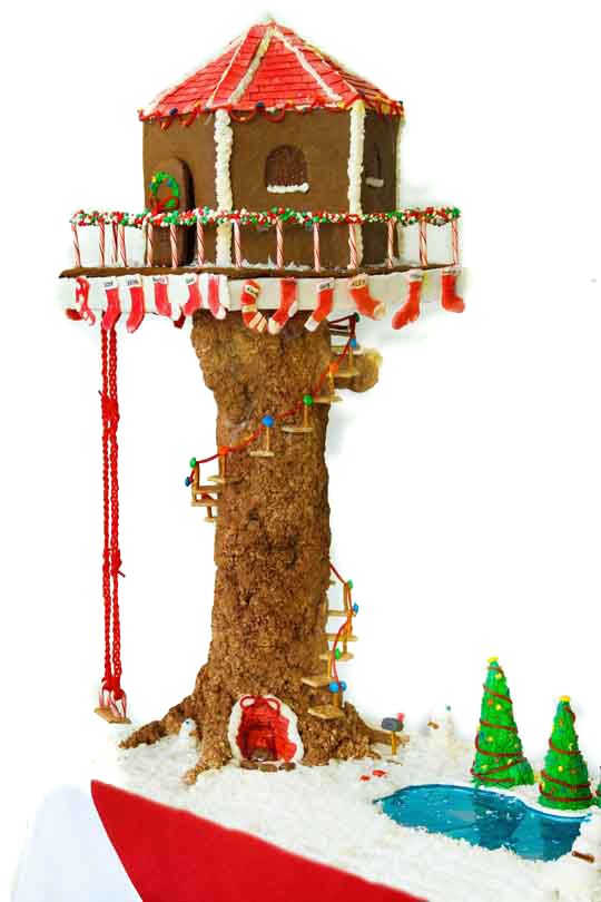 a christmas tree house with lights and decorations on it's roof, in front of a white background