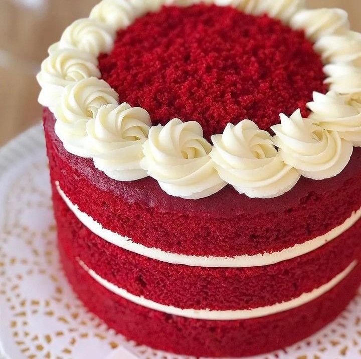 a red velvet cake with white frosting on a plate