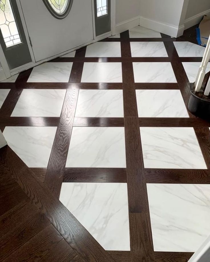 a white and brown tile floor in front of a door