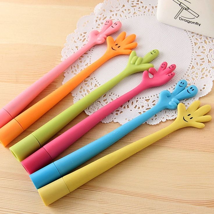 five different colored plastic toothbrushes on a doily