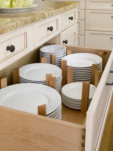 a drawer full of plates in a kitchen