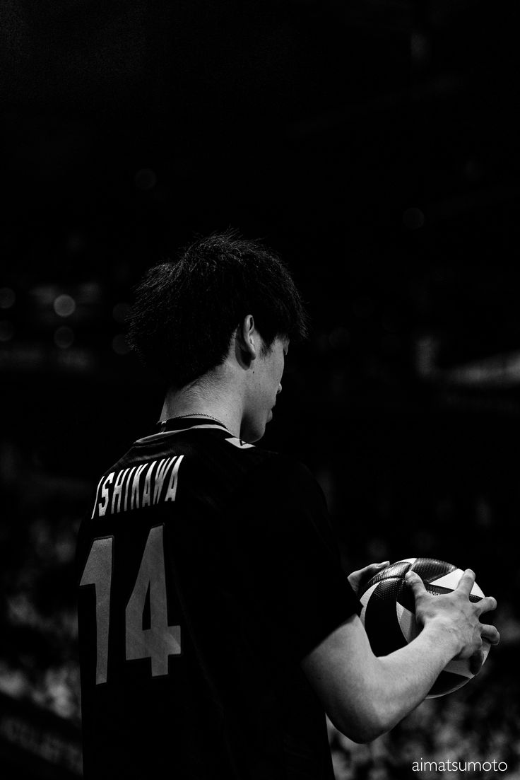 black and white photograph of a man holding a ball