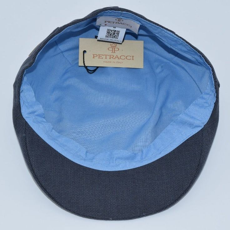 a blue and black hat with a tag on the side that says petraci