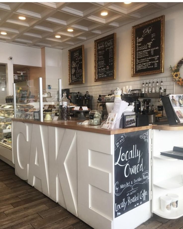 the inside of a coffee shop with chalkboard menus