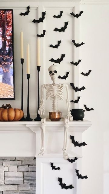 a fireplace decorated for halloween with candles and decorations