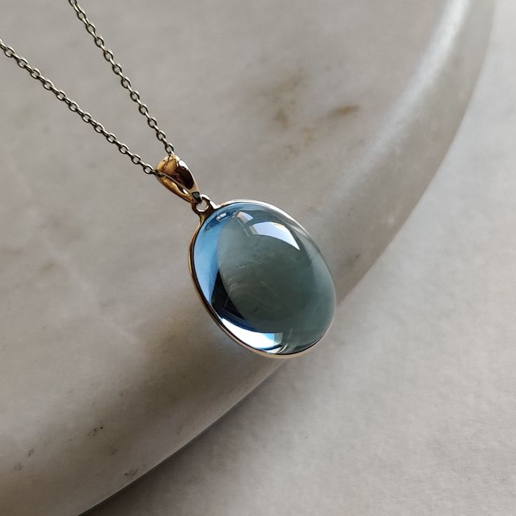 ITEM DESCRIPTION: >>The pendant is made from Solid 14K Yellow Gold. Gemstone used is absolutely natural and ethically sourced. >>Natural Sky Blue Topaz in cabachon and oval shape with bezel setting is studded on it with utmost precision. >>This is a minimalist design and is absolutely hassle-free and everyday jewelry. Gem: Sky Blue Toapz Gem size: 15x20 mm oval Gem weight: 25.7 carats Gold purity: 14K (58.33% approx.) Gold weight: 0.60 grams Gross weight: 5.74 grams The Gold purity is guaranteed Dope Jewelry Accessories, Blue Topaz Jewelry, Handmade Jewelry Box, Blue Topaz Pendant, Topaz Jewelry, Bezel Pendant, Sky Blue Topaz, Unique Gemstones, Fantasy Jewelry