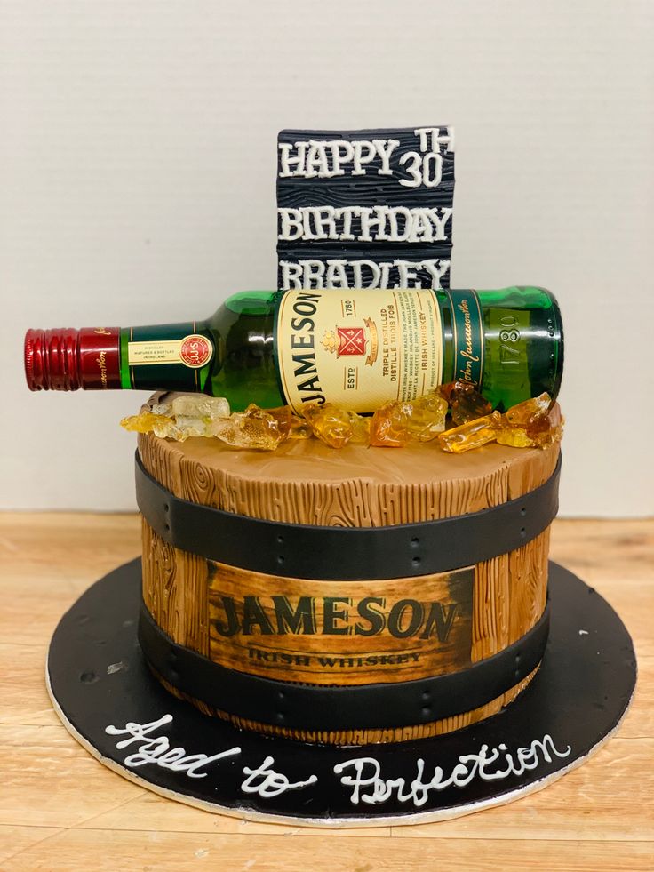 a birthday cake made to look like a barrel with a wine bottle on top and happy 30th bradley