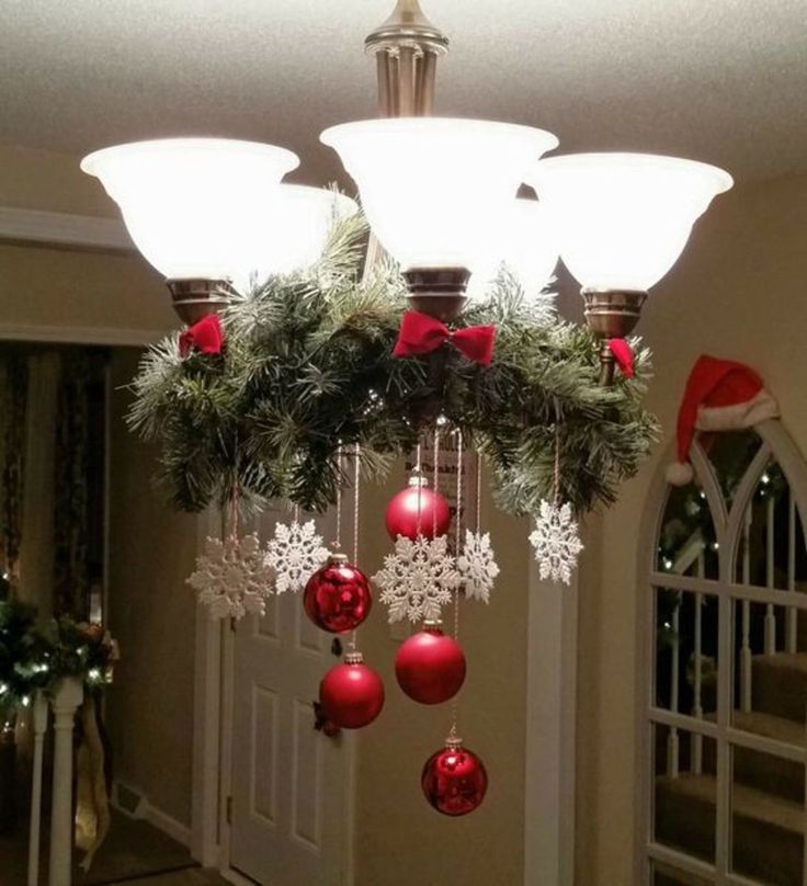 a chandelier with christmas decorations hanging from it