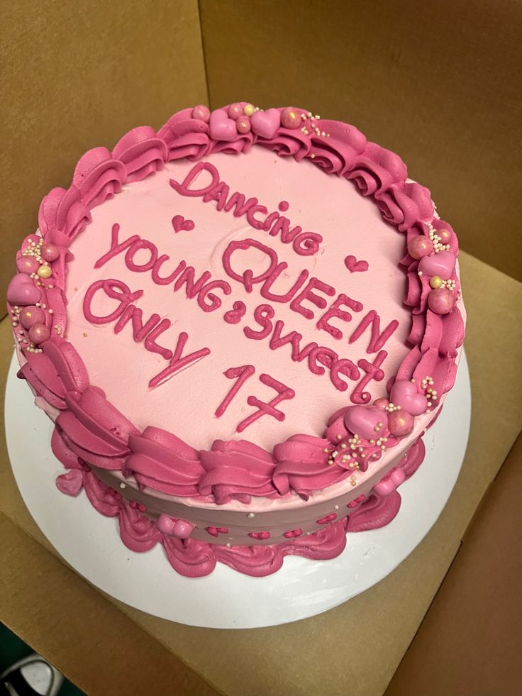 a birthday cake with pink frosting and writing on it