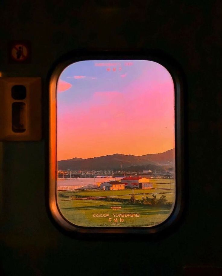 an airplane window looking out at the landscape