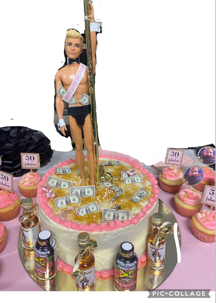 a barbie doll standing on top of a cake surrounded by cupcakes and candy