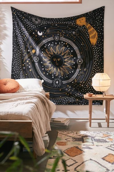 a bedroom with a large tapestry hanging on the wall