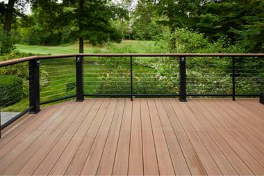 a wooden deck with black rails and railings