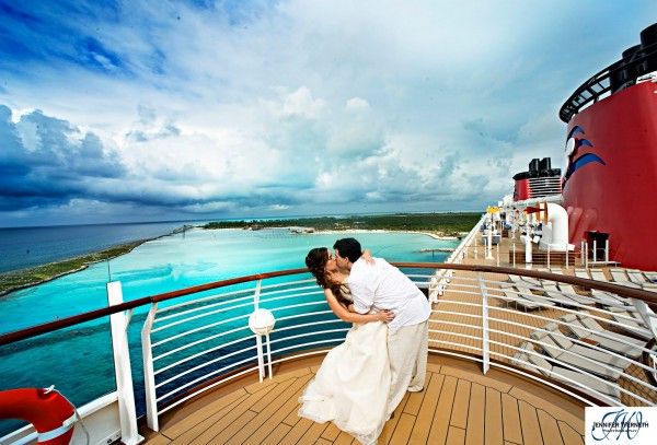 a bride and groom kiss on the deck of a cruise ship as it sails through the ocean