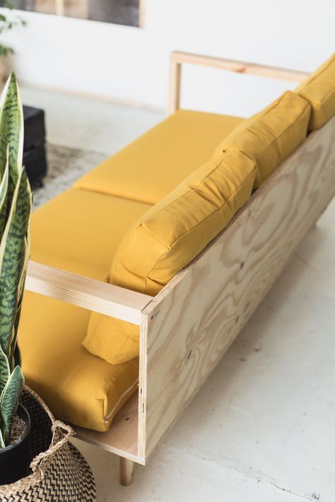 a bench with a plant in it next to a potted plant on the floor