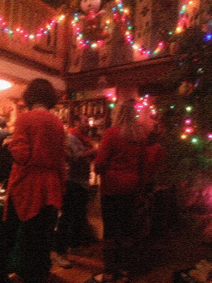 people standing in front of a christmas tree