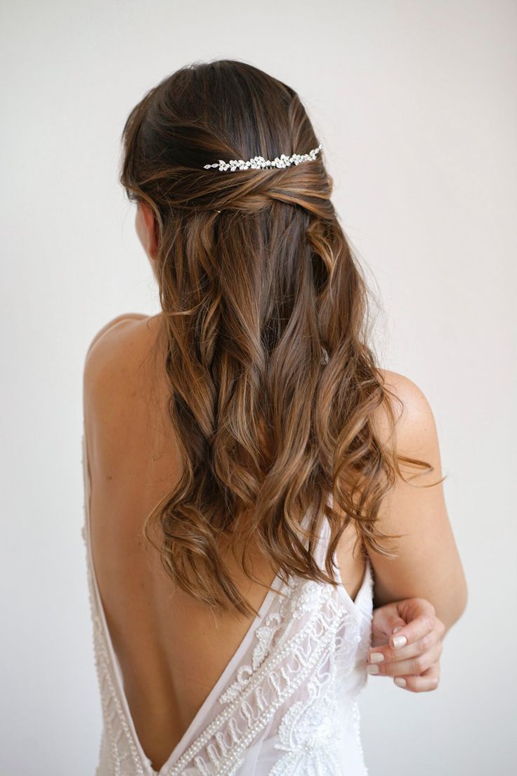 the back of a woman's head wearing a bridal hair piece