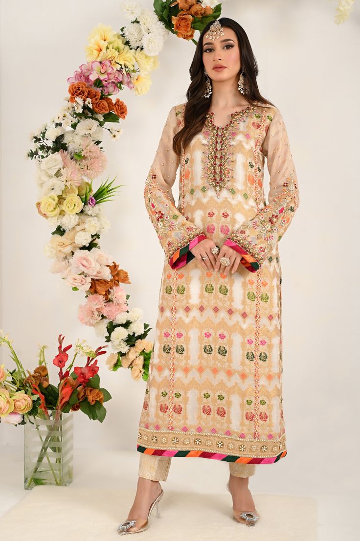 Enchanting A-line multi colour jacquard chiffon shirt is beautified with handwork of crystals, dabka,pearls, kundan colorful resham thread work, flaunting sleeves styled with pearl, bead and sitara work adding grace to this outfit paired with jamawar straight pants, embelished dupatta with boti work all over. Shirt Fabric: Pure Multi colored jacquard chiffon Shirt Length: 48” Pant Fabric: jamawar Dupatta Fabric: chiffon Shirt Color: ivory Pant color: ivory Dupatta Color: ivory All outfits are fu Chinon Embroidered Fabric For Designer Wear, Traditional Multicolor Lawn Suit With Mirror Work, Party Wear Chanderi Blouse With Resham Embroidery, Party Salwar Kameez With Dabka In Multicolor, Party Salwar Kameez With Multicolor Dabka Details, Bollywood Style Multicolor Lawn Suit With Mirror Work, Party Wear Kurta With Mirror Work, Multicolor Silk Dress With Dabka, Party Wear Long Sleeve Kurta With Mirror Work