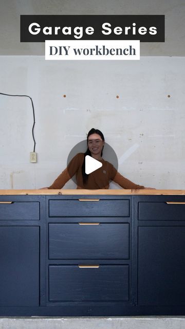 a woman standing in front of a blue cabinet with the words garage series diy workbench