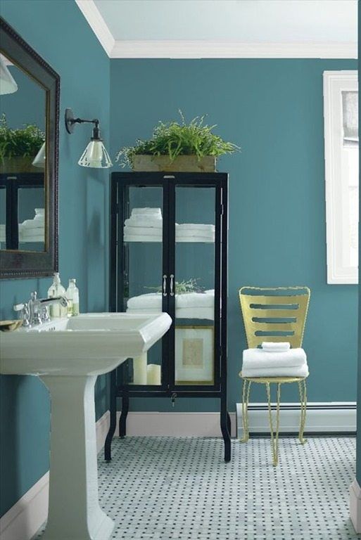 a bathroom with gray walls and white fixtures