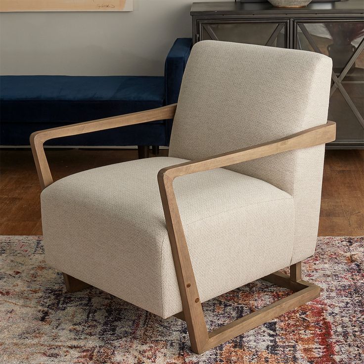 a beige chair sitting on top of a rug