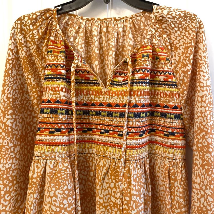 Fashionable Long-Sleeved Boho Flowing Blouse Orange And White With Embroidery Pattern On The Front Colorful Peasant Style 70’s Vibes Condition Is Brand New Never Worn 100% Polyester Women’s Medium Fits True To Size Bohemian Multicolor Blouse With Vintage Print, Fall Patterned Cotton Blouse, Folk Style Tunic Blouse For Fall, Cotton Peasant Top With Boho Print, Bohemian Patterned Tops With Vintage Print, Bohemian Patterned Top With Vintage Print, Hippie Printed Blouse For Fall, Bohemian Tops With Vintage Print, Spring Patterned Tunic Blouse