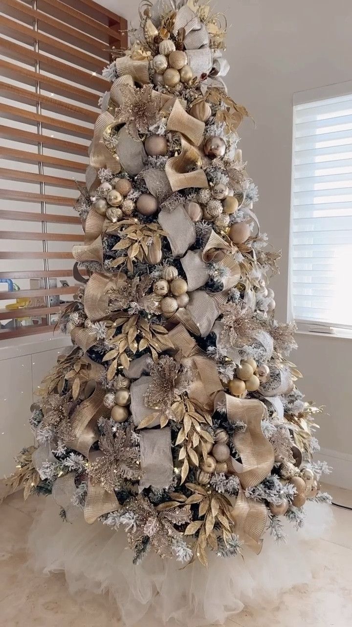 a christmas tree decorated with gold and silver ornaments