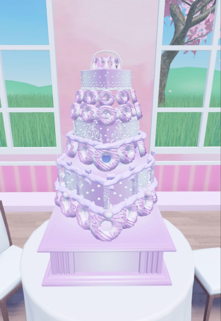 a three tiered cake sitting on top of a table in front of a window