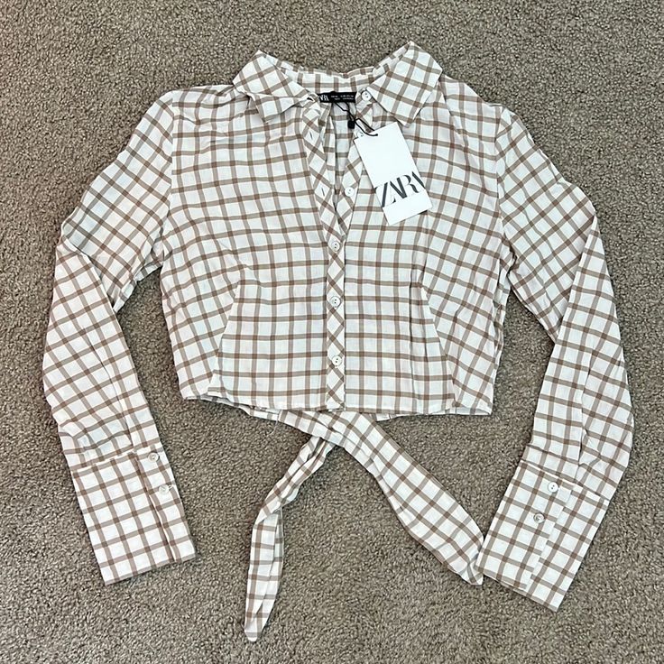 Zara Size Xs Never Worn (Tags Still Attached) Button Down Cropped Top With Open Back That Ties At Waist Cream And Taupe Checkered Top Fall Cropped Shirt For Day Out, Fitted Brown Spring Shirt, Brown Fitted Shirt For Spring, Fitted Brown Shirt For Spring, Zara Cropped Brown Top, Zara Brown Top For Day Out, Beige Button-up Top From Zara, Zara Beige Button-up Top, Beige Button-up Zara Top