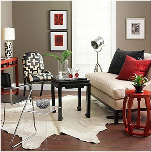 a living room filled with furniture and red walls