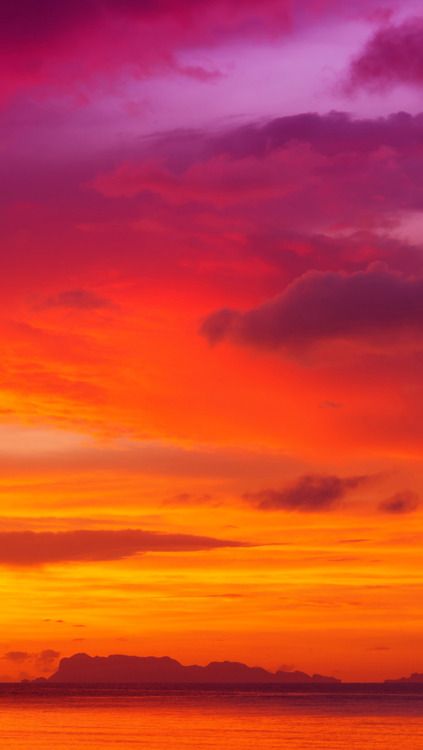 an orange and purple sunset over the ocean