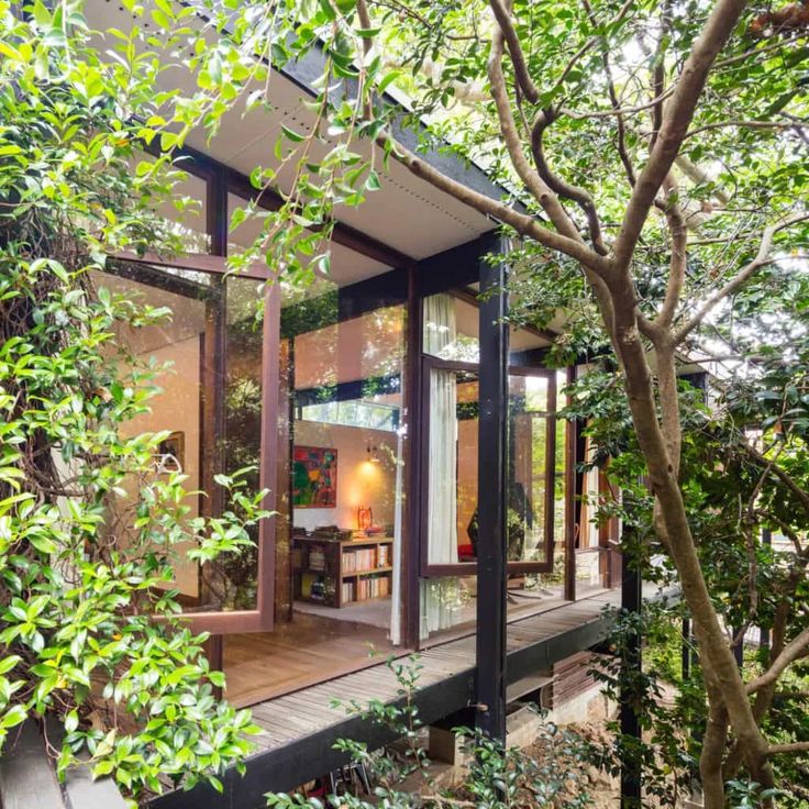 a house that is surrounded by trees and plants