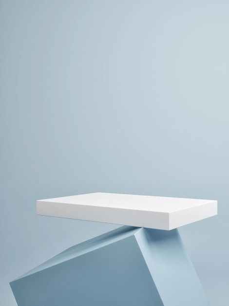 an empty white table sitting on top of a blue surface in front of a gray wall