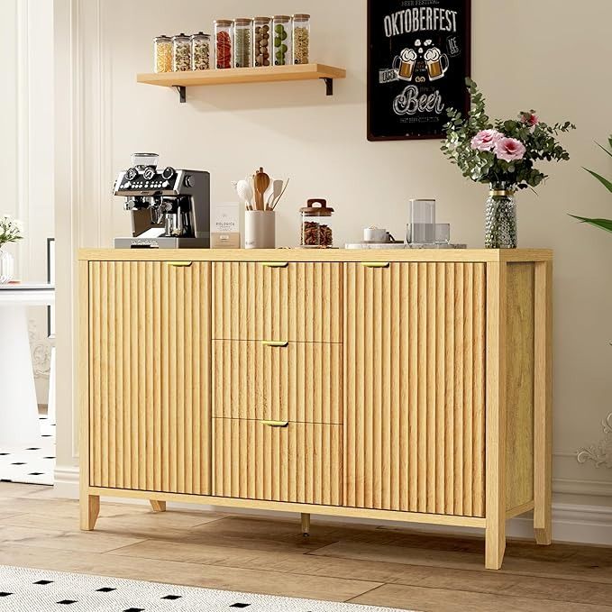 a wooden cabinet sitting in the middle of a living room next to a potted plant