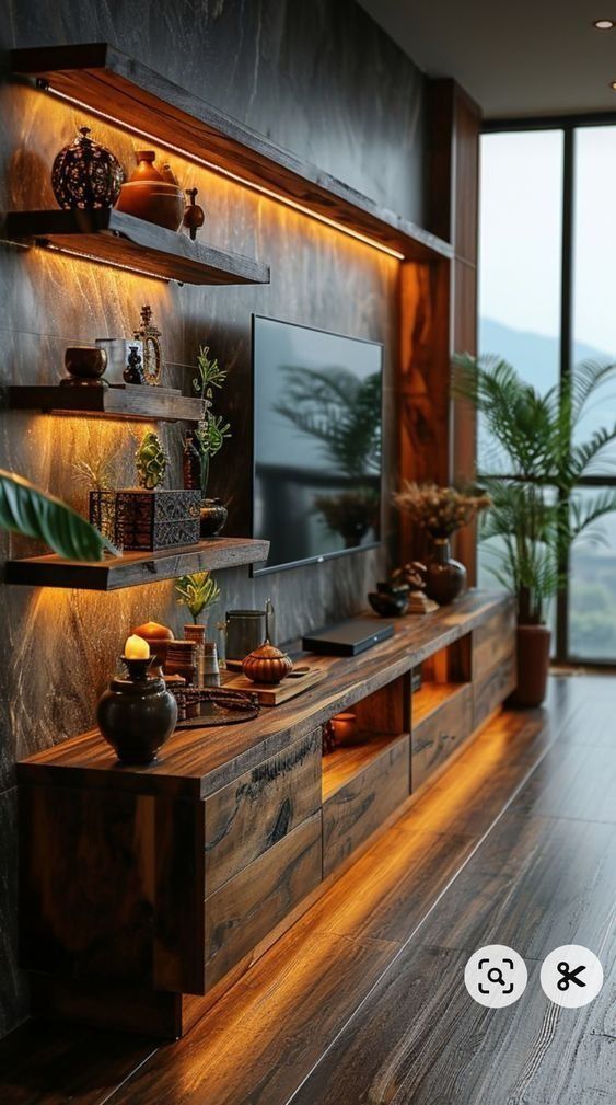 a living room with wood flooring and built - in entertainment center surrounded by large windows