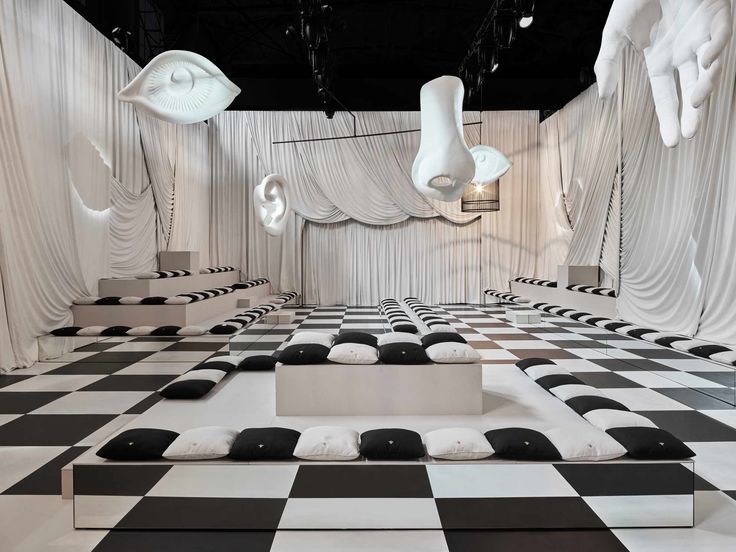 an artistic room with black and white checkered flooring